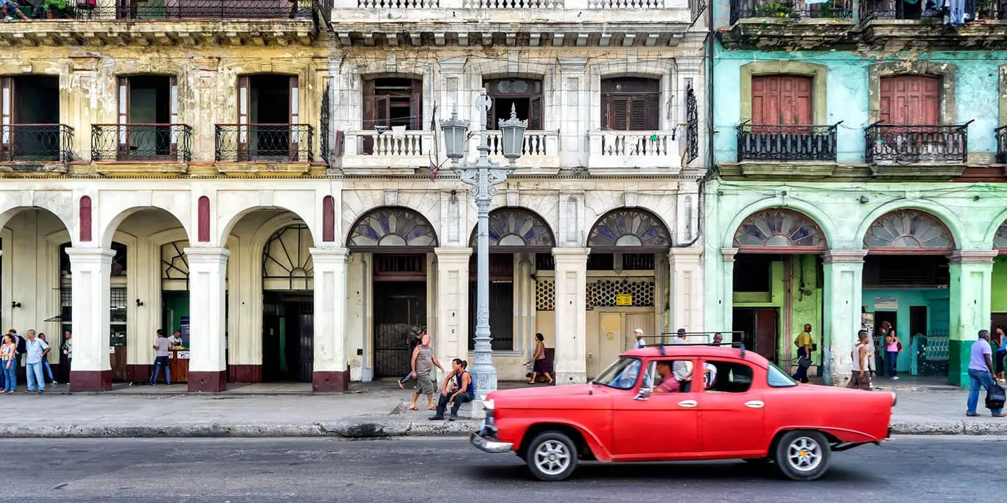 Red Colored Car Parked In front of the Building